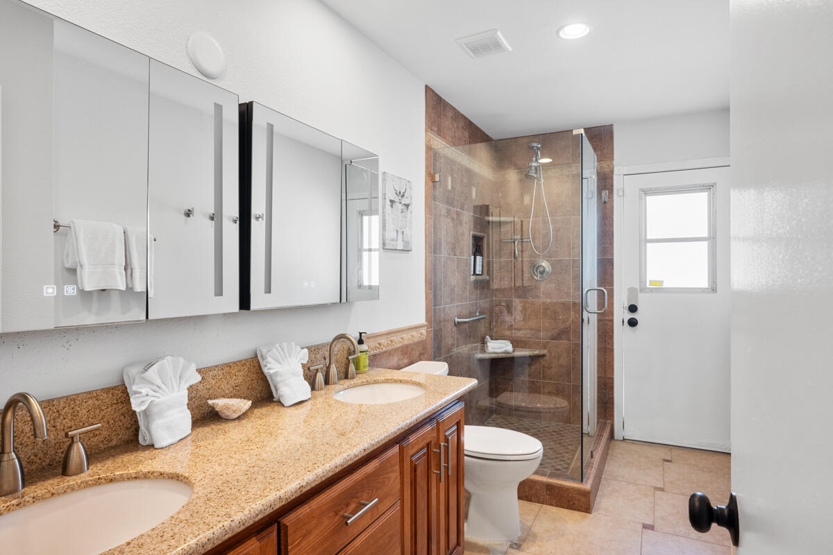 2450 Tamarisk Road Palm Springs, CA 92262 - Photo 27 of 41 a bathroom with a granite countertop sink toilet and shower