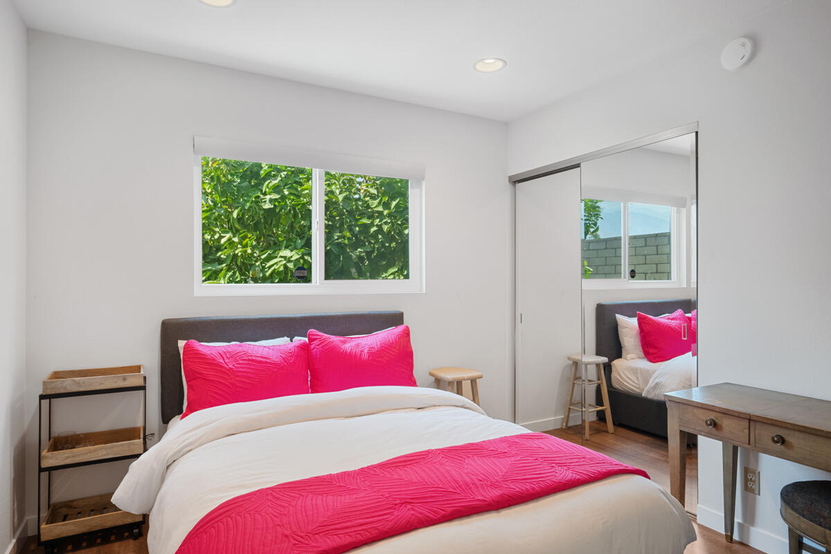 2450 Tamarisk Road Palm Springs, CA 92262 - Photo 29 of 41 a bedroom with a bed and wooden floor