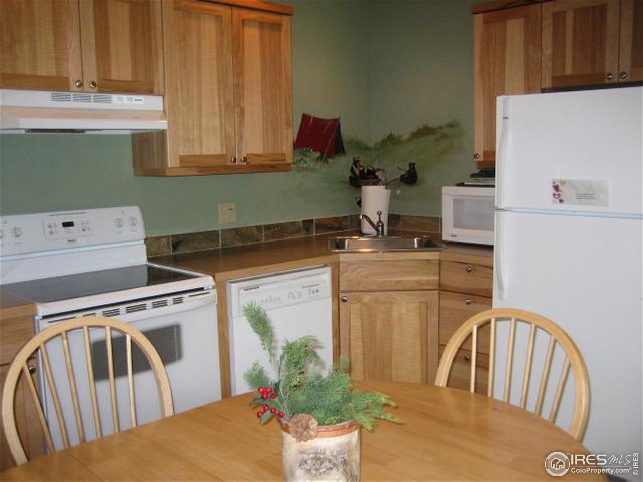 2100 Fall River Road, Unit 6 Estes Park, CO 80517 - Photo 3 of 6 a kitchen with a stove a sink cabinetry and a kitchen island