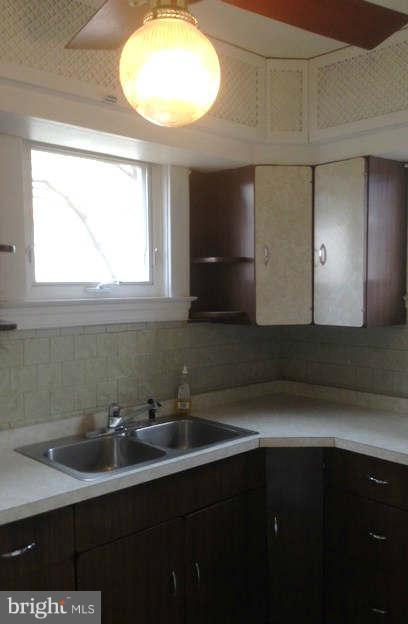 6916 Sollers Point Road Baltimore, MD 21222 - Photo 14 of 25 a bathroom with a sink and a mirror