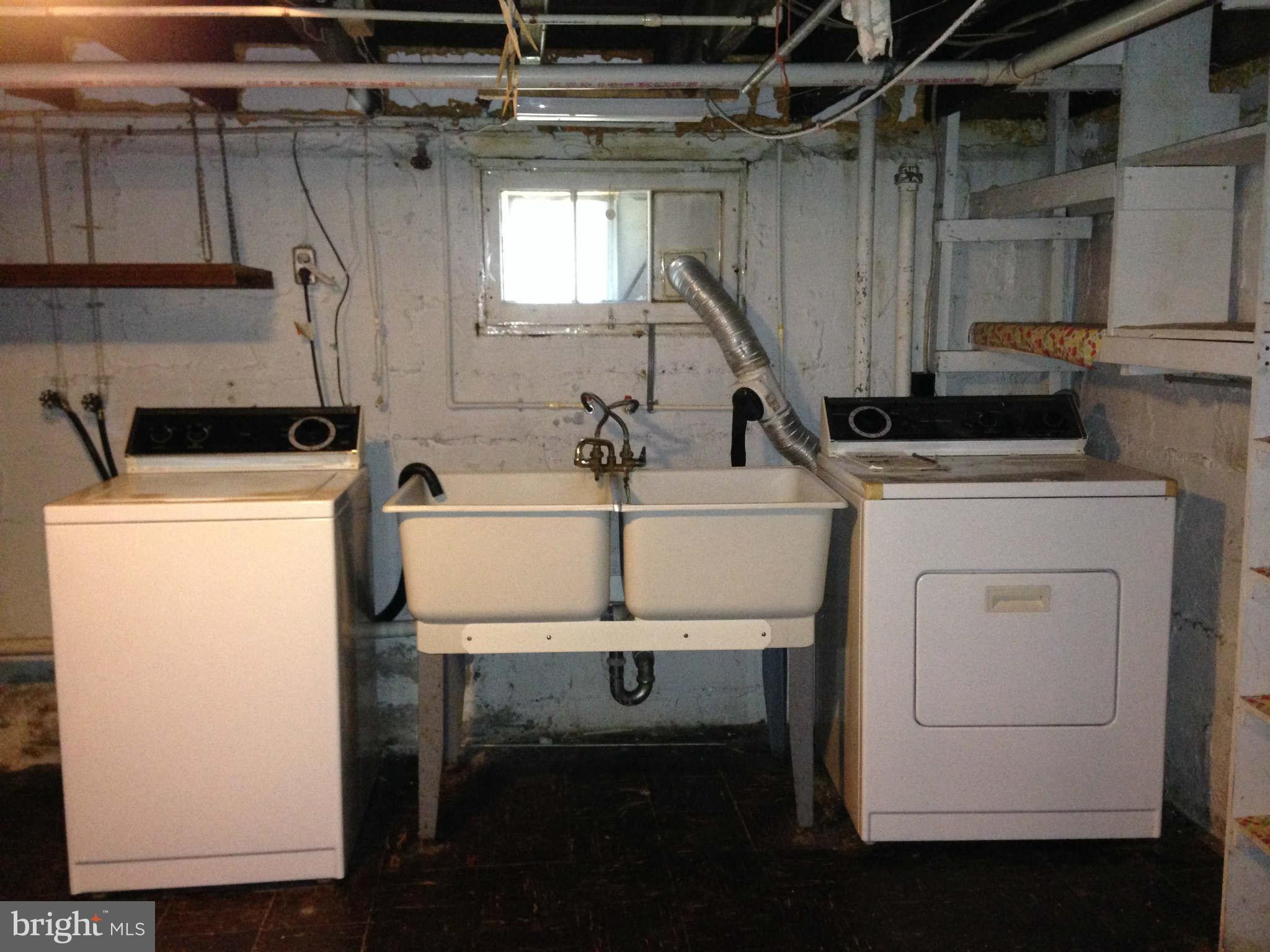6916 Sollers Point Road Baltimore, MD 21222 - Photo 22 of 25 a kitchen with a sink and a washer dryer