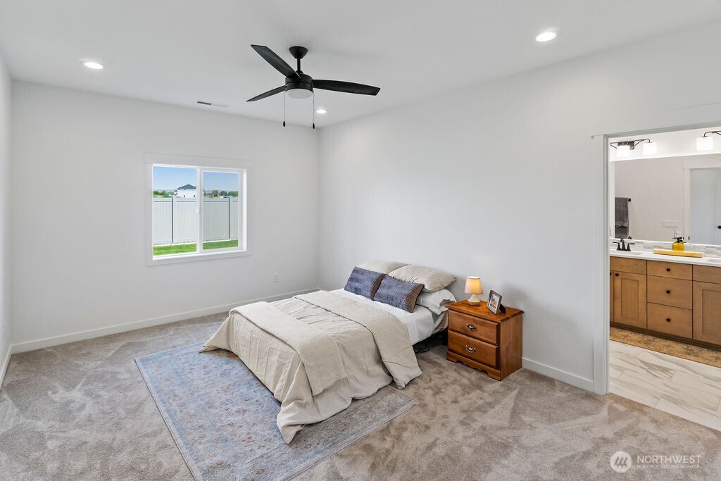 231 Shrute Road Prosser, WA 99350 - Photo 13 of 36 a bedroom with a bed a dresser and flowerpot