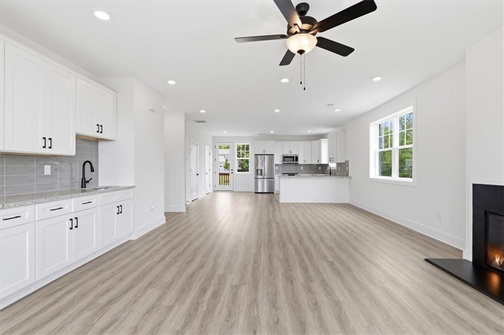 208 Mission Way Atlanta, GA 30315 - Photo 14 of 43 a large kitchen with cabinets wooden floor and a window