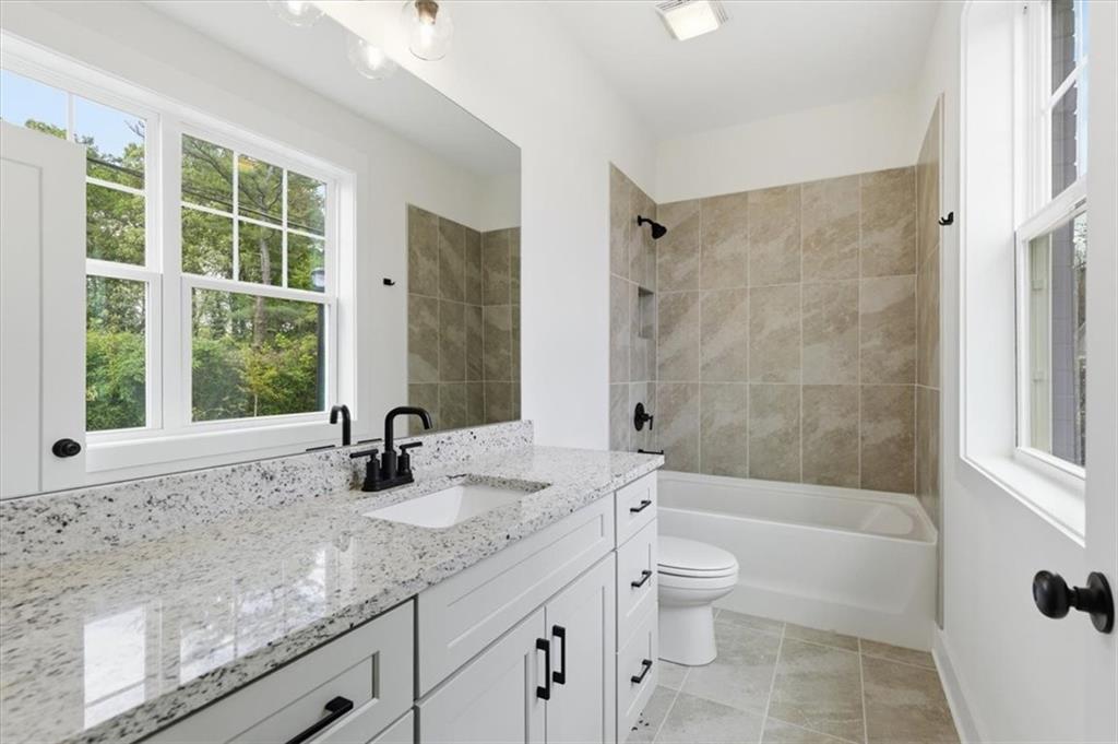 208 Mission Way Atlanta, GA 30315 - Photo 23 of 43 a bathroom with a granite countertop bathtub shower sink vanity and toilet