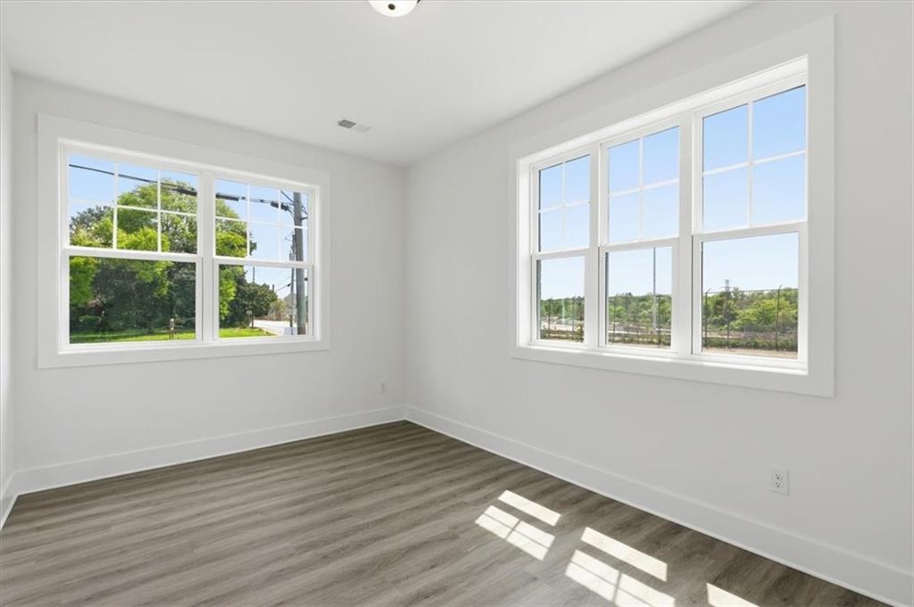 208 Mission Way Atlanta, GA 30315 - Photo 24 of 43 a view of an empty room with wooden floor and a window