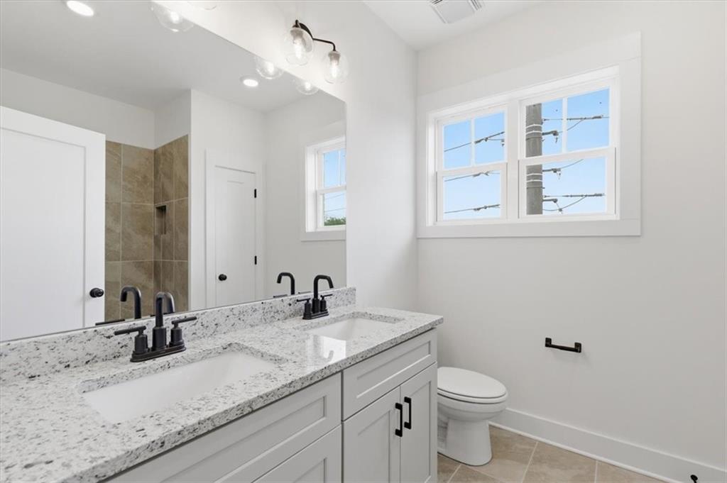 208 Mission Way Atlanta, GA 30315 - Photo 31 of 43 a bathroom with a granite countertop sink mirror and toilet