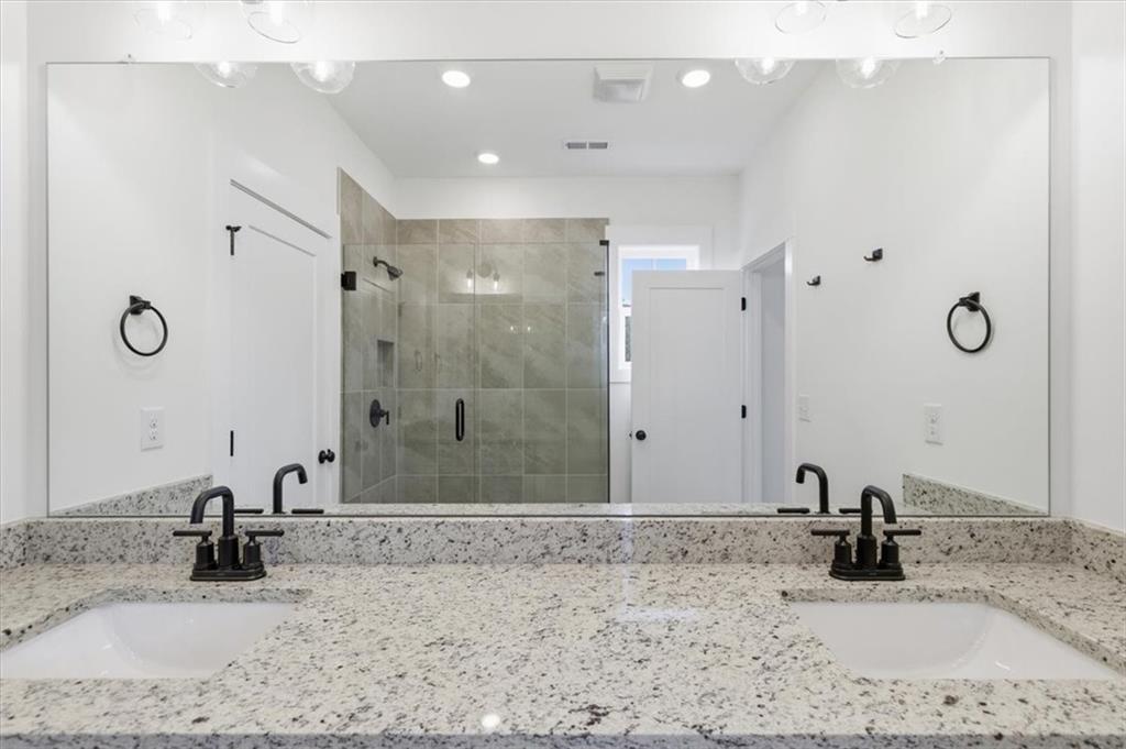 208 Mission Way Atlanta, GA 30315 - Photo 36 of 43 a bathroom with a granite countertop sink a mirror and shower