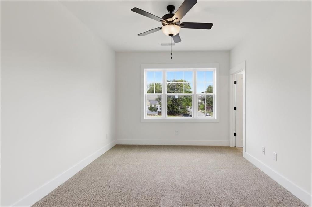 208 Mission Way Atlanta, GA 30315 - Photo 37 of 43 an empty room with a window and a ceiling fan