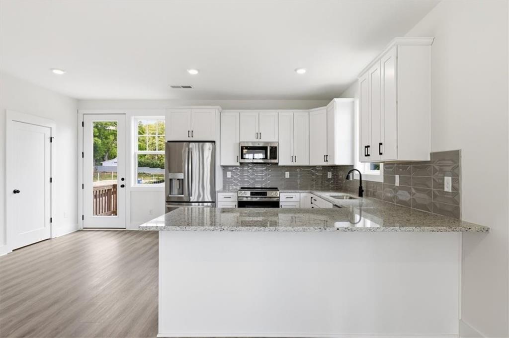 208 Mission Way Atlanta, GA 30315 - Photo 5 of 43 a kitchen with stainless steel appliances granite countertop a refrigerator sink and cabinets
