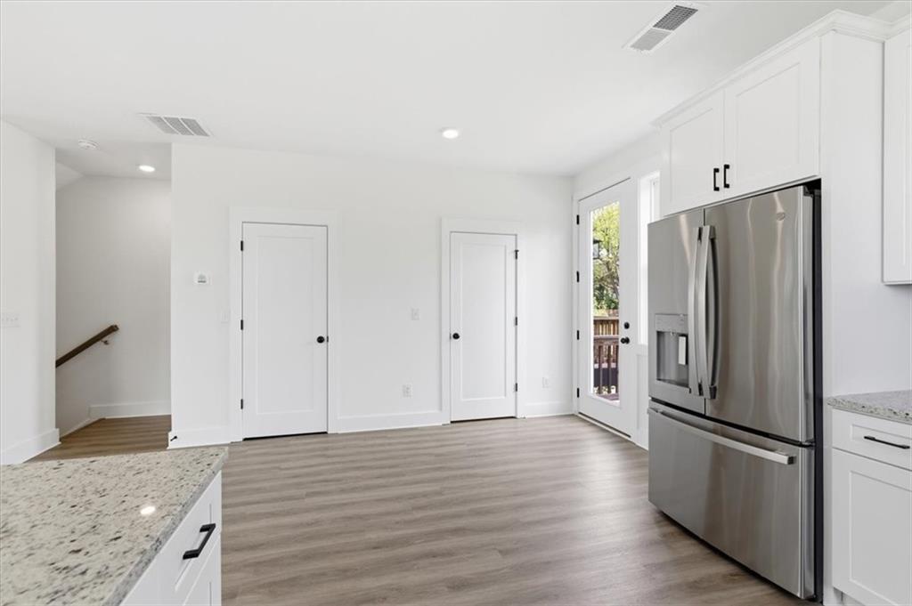 208 Mission Way Atlanta, GA 30315 - Photo 8 of 43 a view of a kitchen with refrigerator and wooden floor