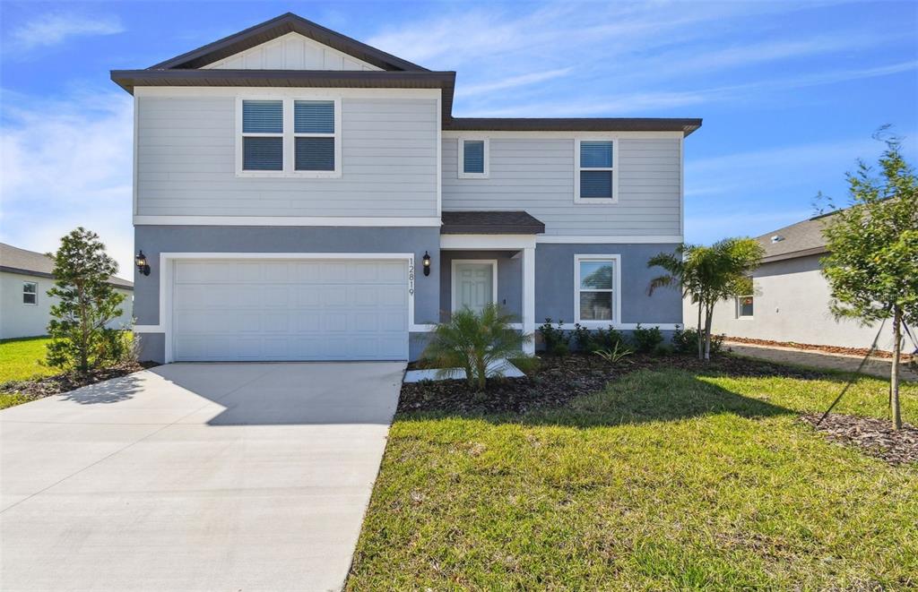 12819 Wanderlust Place Parrish, FL 34219 - Photo 1 of 1 a front view of a house with a yard