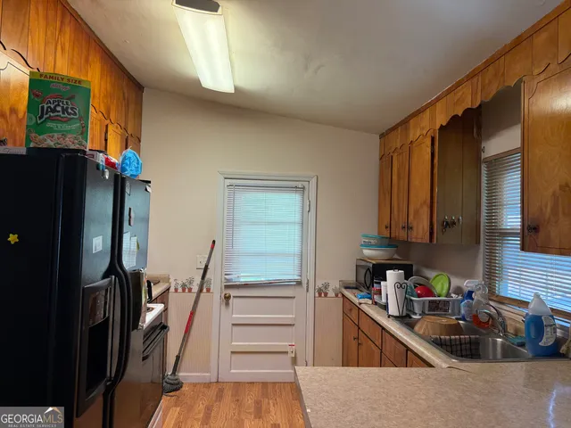 a kitchen with stainless steel appliances a refrigerator and a sink