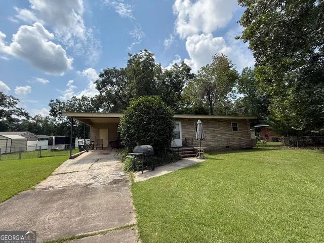 a swimming pool with outdoor seating and yard