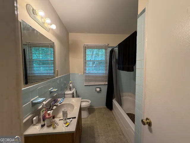 a bathroom with a sink a mirror and a shower