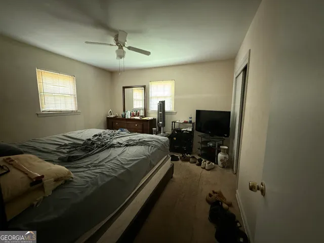 a bedroom with a bed and a television