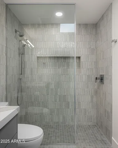 a bathroom with a toilet and a shower