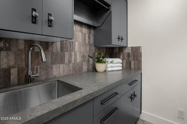 a kitchen with a sink and cabinets