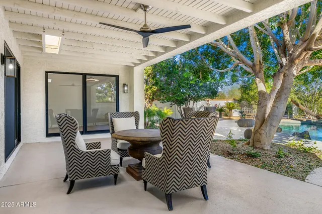 a view of a porch with furniture and a yard