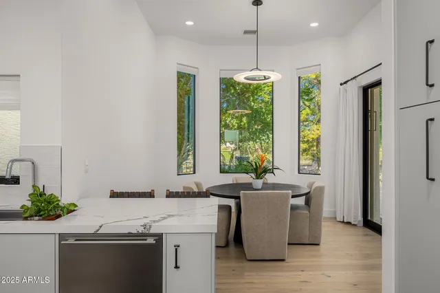 a kitchen with stainless steel appliances a sink a counter space and a window