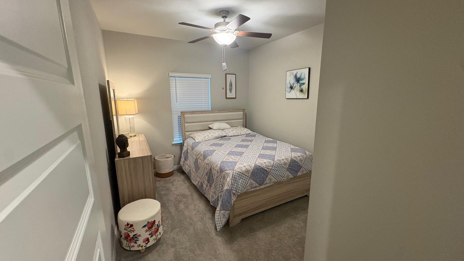 6511 Dragride Road Buda, TX 78610 - Photo 19 of 36 Well-lit sleeping quarters with a ceiling fan for comfort.