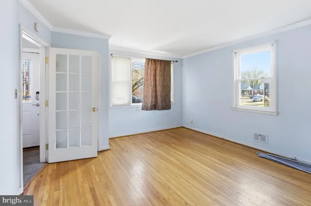 a view of a bedroom with wooden floor and a bathroom