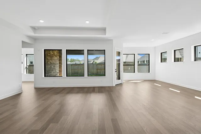 a large kitchen with stainless steel appliances granite countertop a lot of counter space and wooden floors
