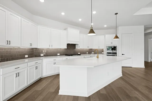 a view of an empty room with wooden floor and closet