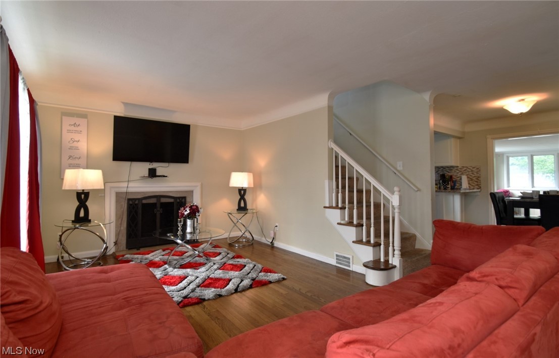 4205 Okalona Road South Euclid, OH 44121 - Photo 2 of 21 Hardwood floored living room with a fireplace.
