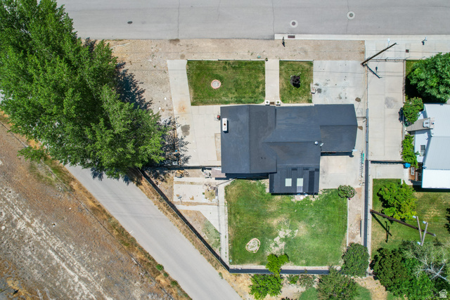 100 Third North Helper, UT 84526 - Photo 12 of 30 Property featuring a dark shingle roof, concrete driveway, and front and rear lawn areas