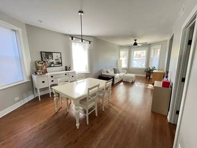 a living room with furniture window and wooden floor