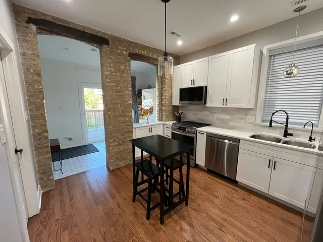 a kitchen with a sink a microwave a stove and refrigerator