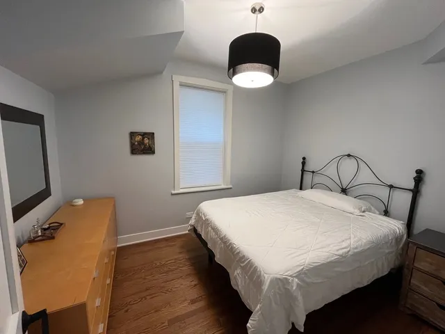 a bedroom with a bed and a chandelier