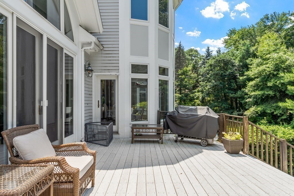 84 Monument Farm Road Concord, MA 01742 - Photo 13 of 34 a view of a patio with couches table and chairs and potted plants