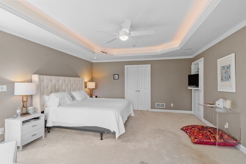 84 Monument Farm Road Concord, MA 01742 - Photo 18 of 34 a bedroom with a bed and a lamp