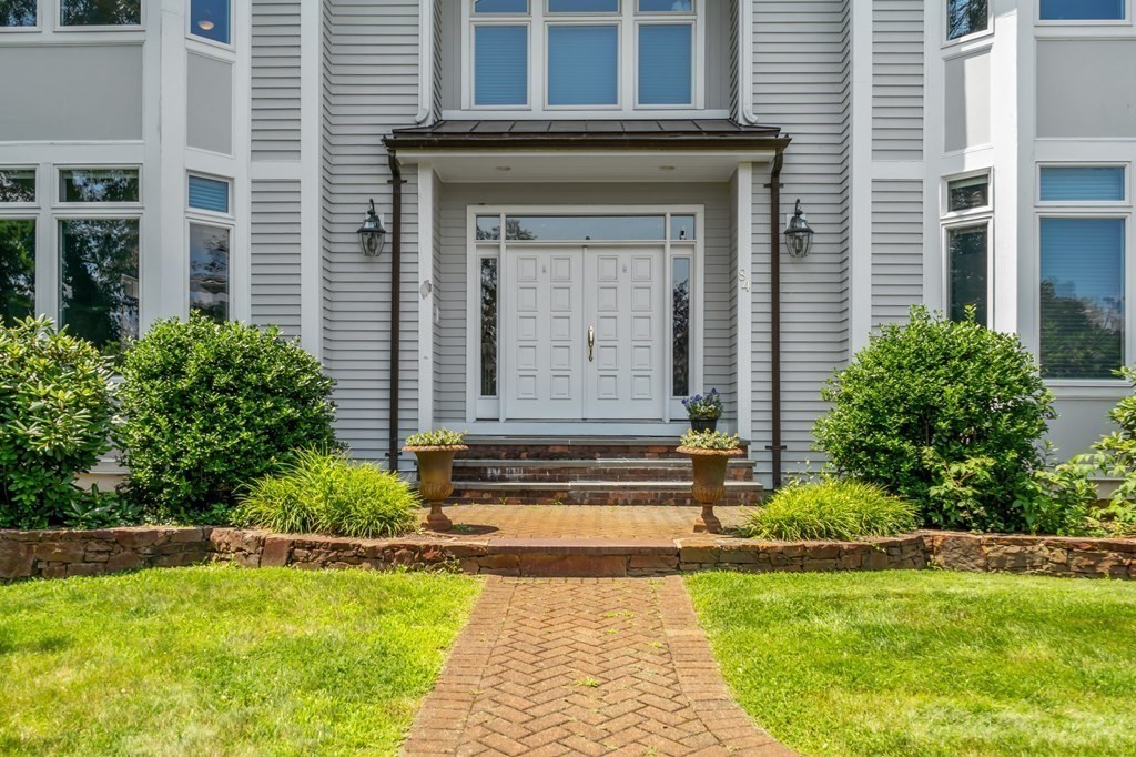 84 Monument Farm Road Concord, MA 01742 - Photo 2 of 34 a front view of a house with a yard