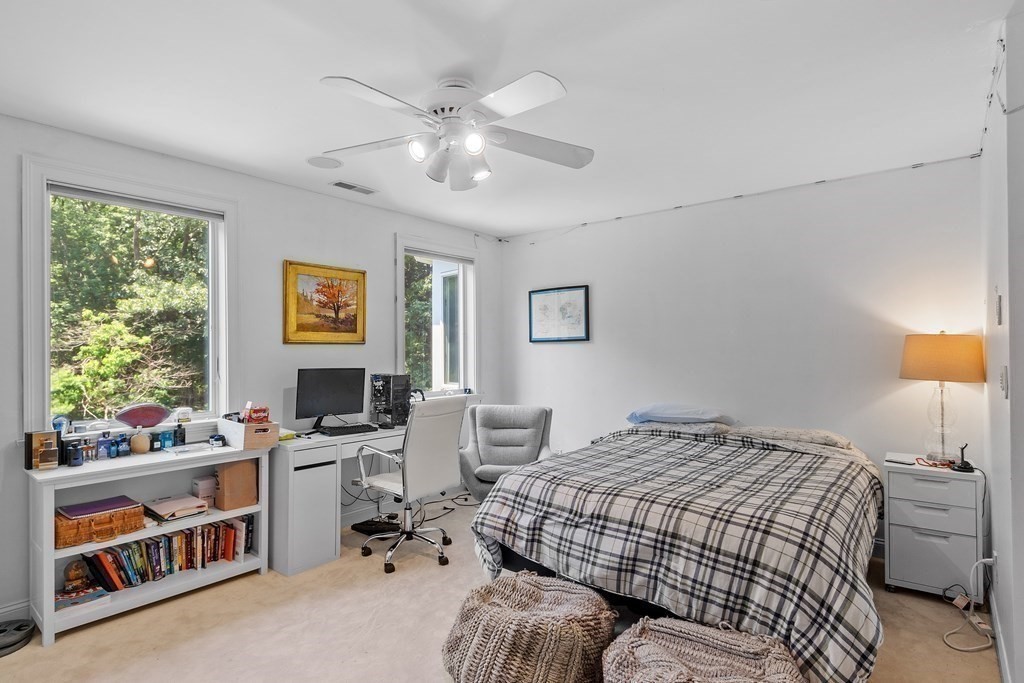 84 Monument Farm Road Concord, MA 01742 - Photo 21 of 34 a bedroom that has a bed and a table in it