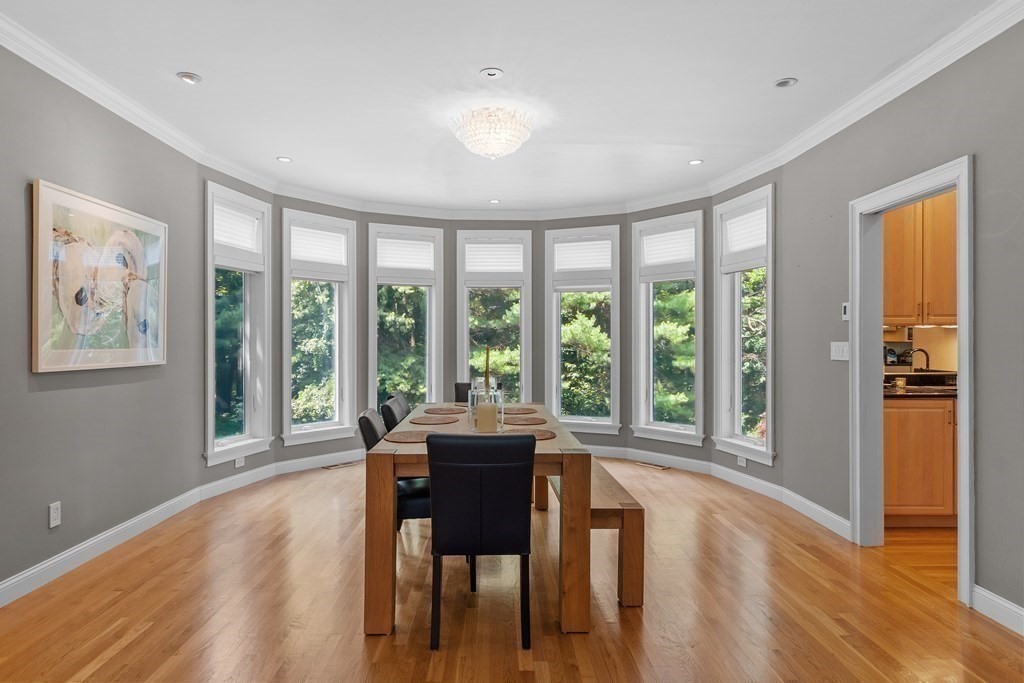 84 Monument Farm Road Concord, MA 01742 - Photo 7 of 34 a view of a dining room with furniture large windows and wooden floor