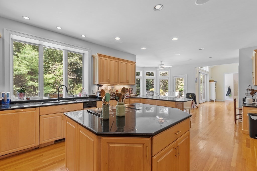 84 Monument Farm Road Concord, MA 01742 - Photo 8 of 34 a kitchen with kitchen island granite countertop a large window