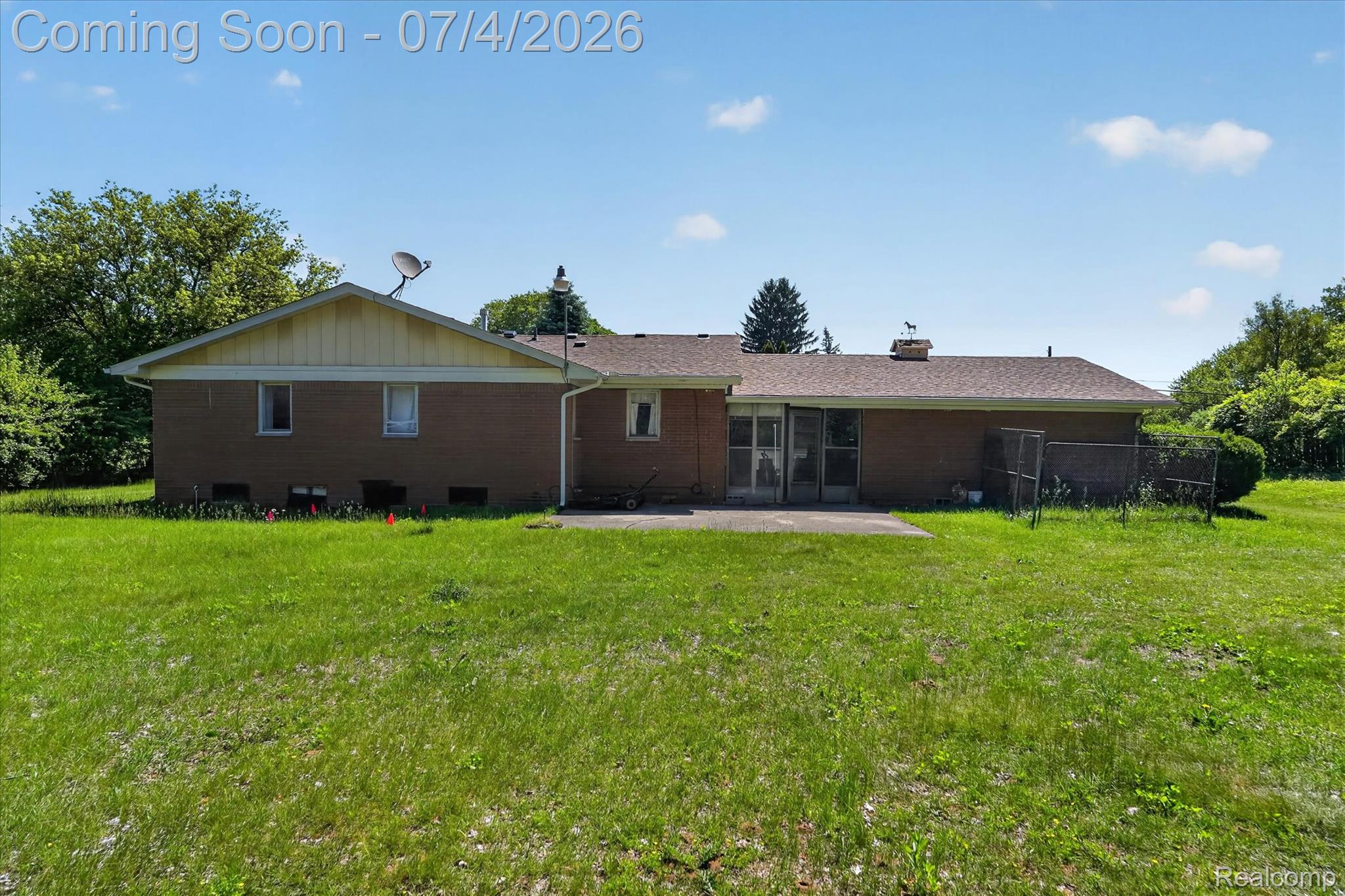 2091 North Irish Road Davison, MI 48423 - Photo 20 of 25 Brown brick exterior with a pitched shingle roof