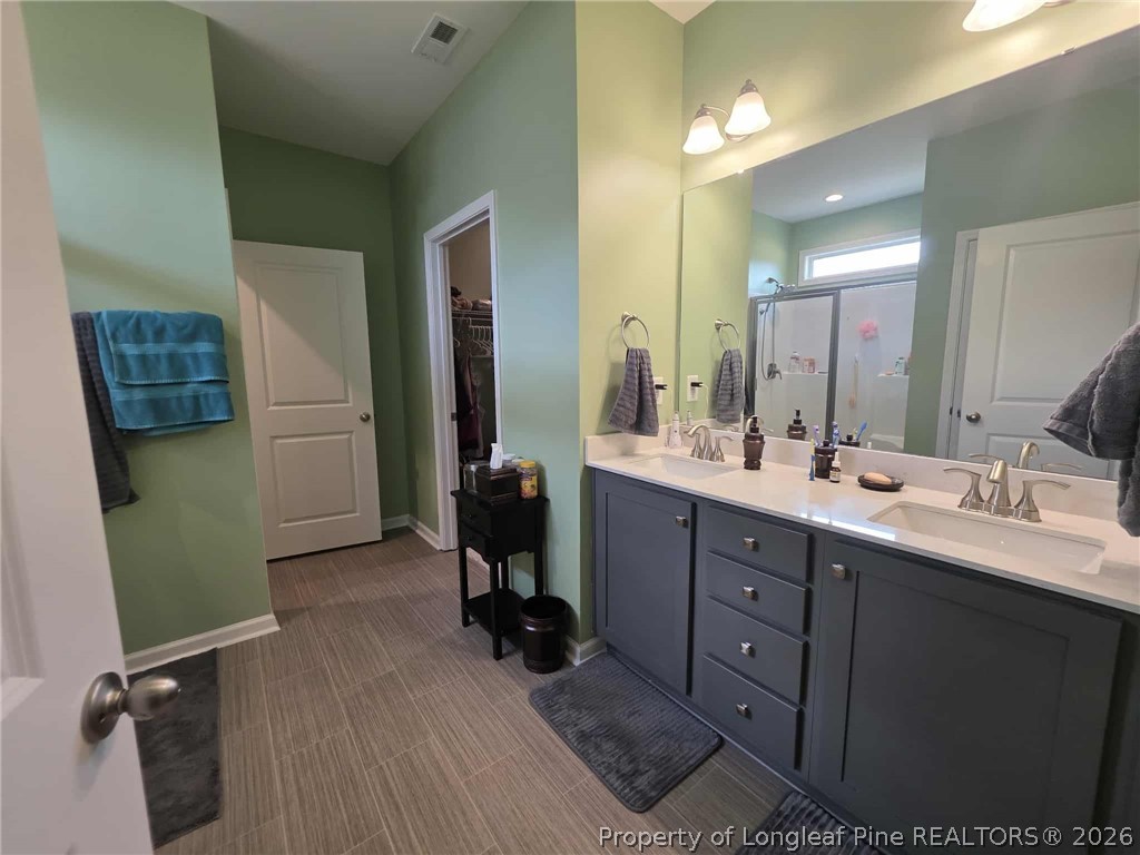 317 Laurel Lake Road Salemburg, NC 28385 - Photo 11 of 29 a bathroom with a double vanity sink and a mirror
