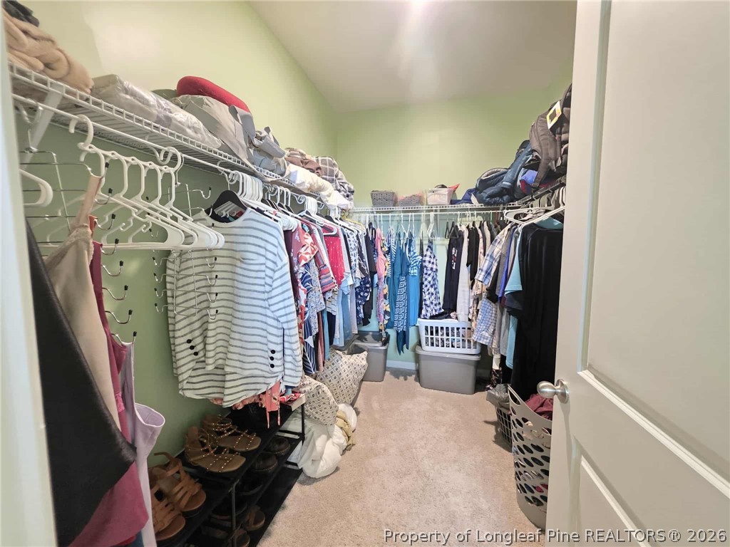 317 Laurel Lake Road Salemburg, NC 28385 - Photo 12 of 29 a view of walk in closet with clothes and shoes