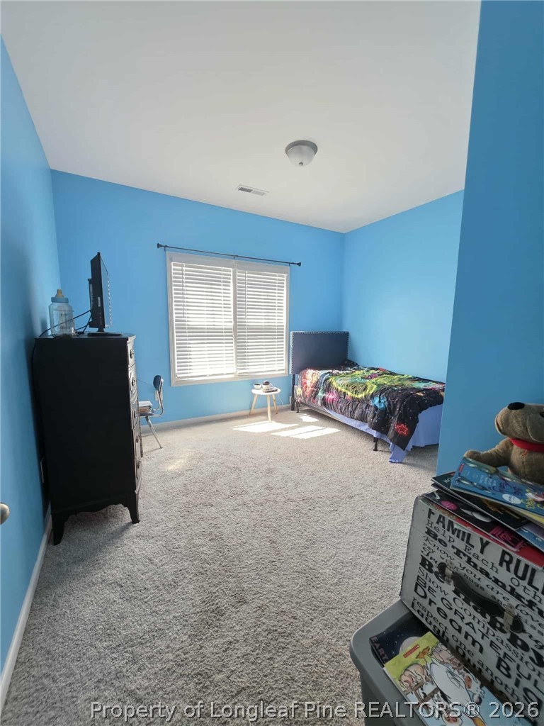 317 Laurel Lake Road Salemburg, NC 28385 - Photo 16 of 29 a bedroom with furniture and a window