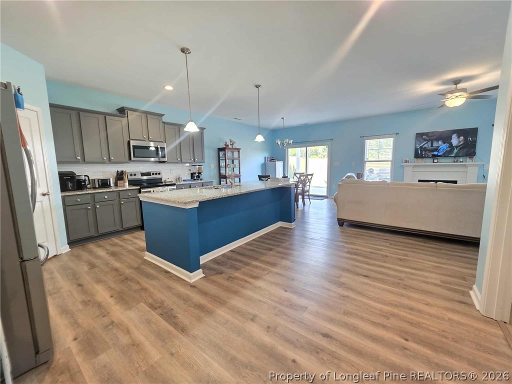 317 Laurel Lake Road Salemburg, NC 28385 - Photo 22 of 29 a kitchen with stainless steel appliances granite countertop a stove refrigerator and a sink