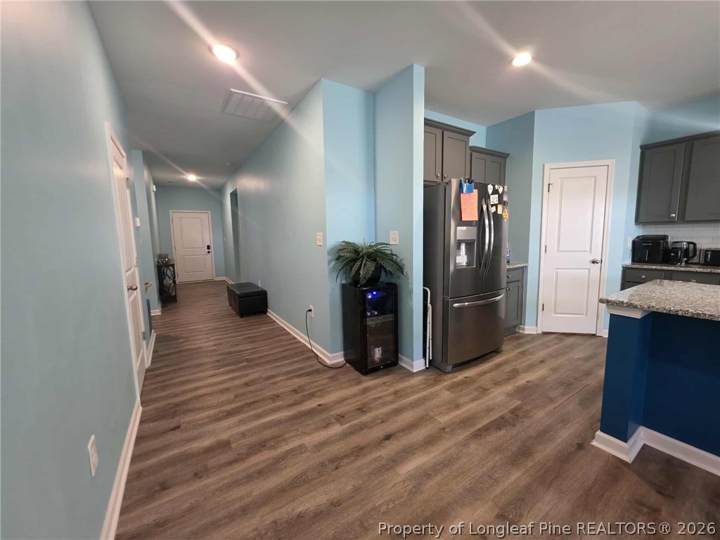 317 Laurel Lake Road Salemburg, NC 28385 - Photo 25 of 29 a view of a kitchen with refrigerator and wooden floor