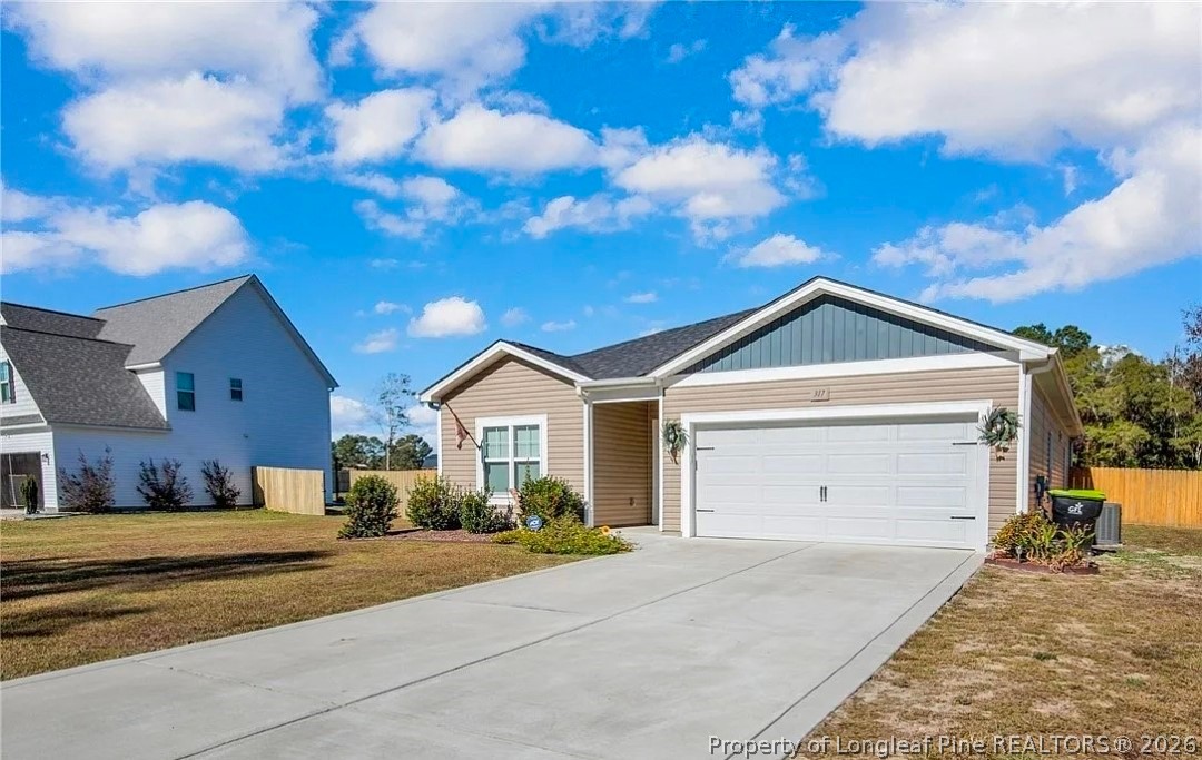 317 Laurel Lake Road Salemburg, NC 28385 - Photo 3 of 29 a front view of a house with a yard and garage