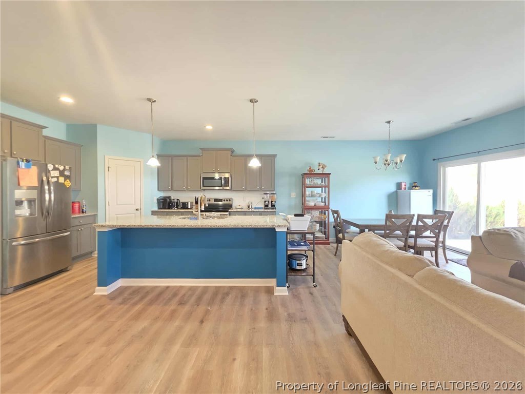 317 Laurel Lake Road Salemburg, NC 28385 - Photo 5 of 29 a kitchen with stainless steel appliances kitchen island granite countertop a large counter top stainless steel appliances and cabinets