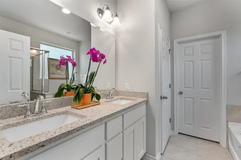 a white bath tub sitting next to a shower