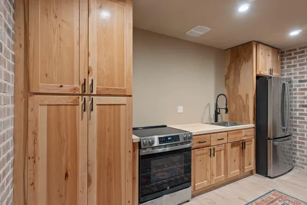 a kitchen with a stove sink and refrigerator