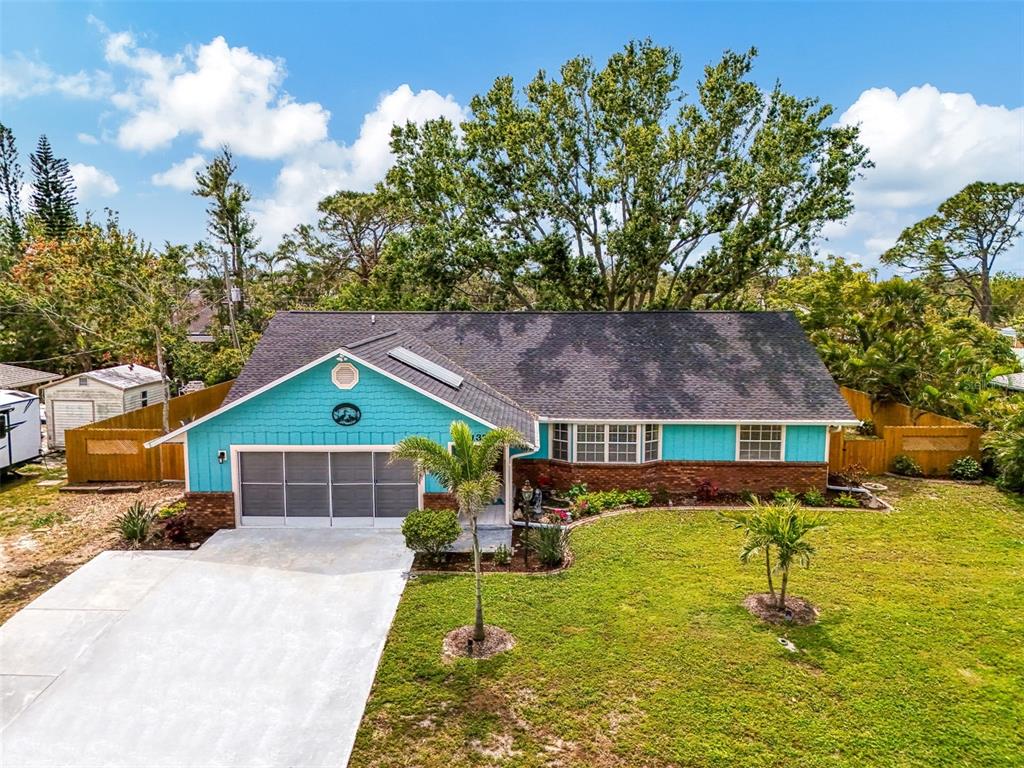 1137 Ponderosa Road Venice, FL 34293 - Photo 48 of 48 a house view with swimming pool and trees in the background