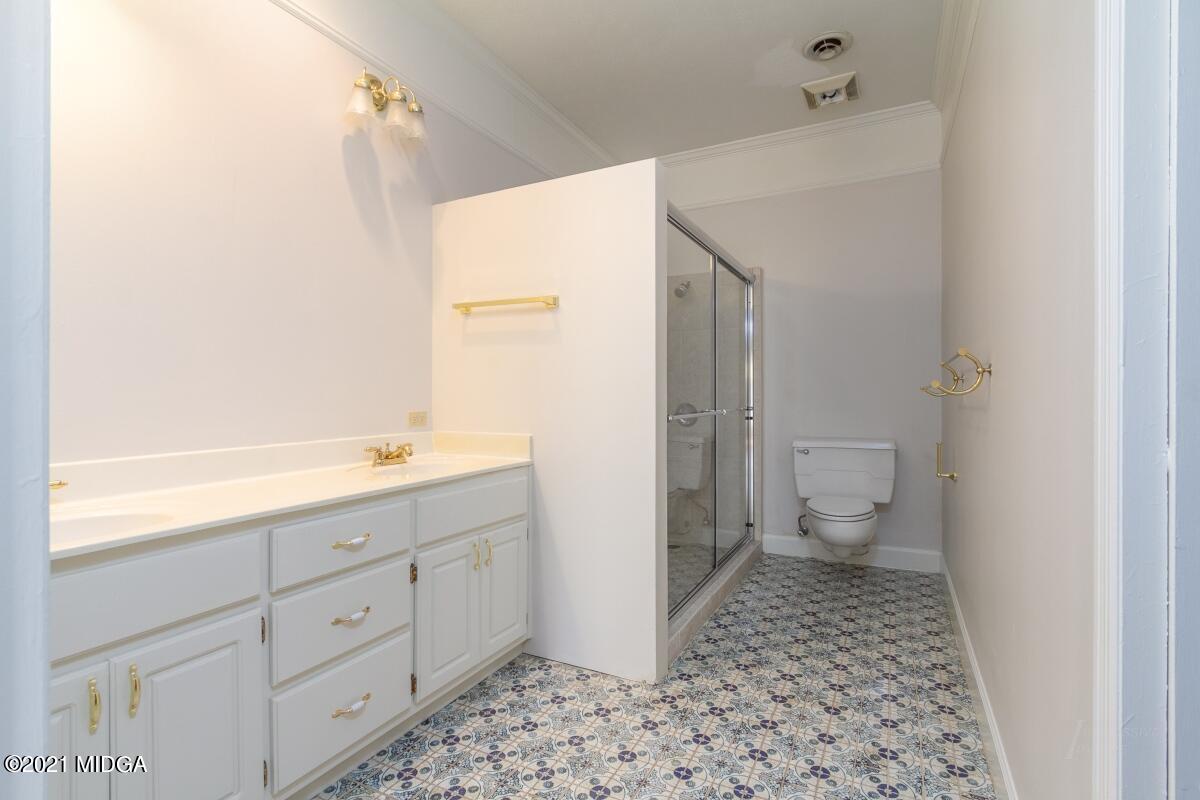 903 Tucker Road Macon, GA 31210 - Photo 17 of 31 a bathroom with a sink a toilet and a shower